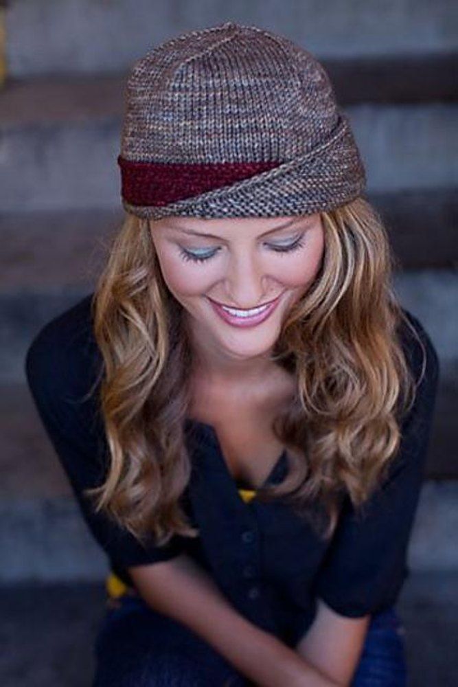 a woman wearing a hat and looking at her cell phone