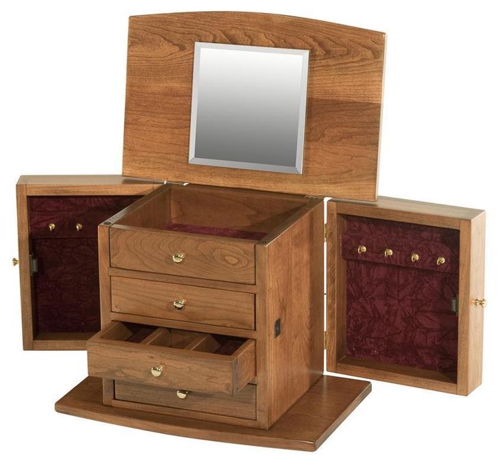 a wooden jewelry box with two drawers and a mirror on the top one drawer is open