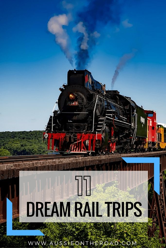 a train traveling over a bridge with the words dream rail trips on it's side