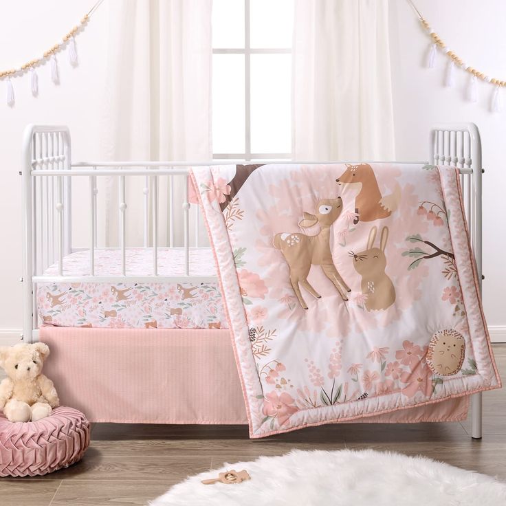 a baby crib with pink and white bedding, teddy bear rugs and curtains