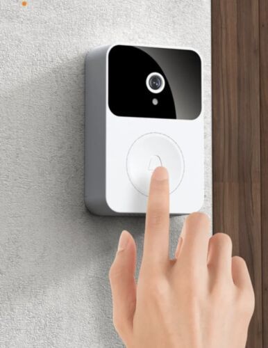 a person pressing the button on a smart home security system that is mounted to a wall