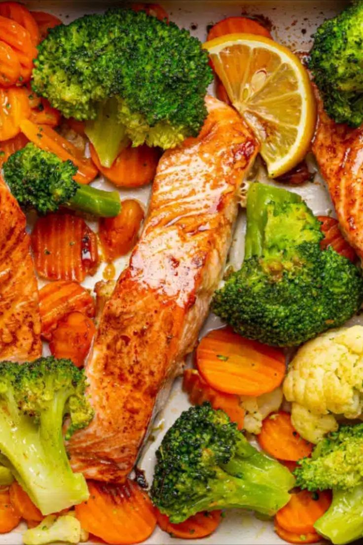 salmon, broccoli, cauliflower and carrots in a baking dish