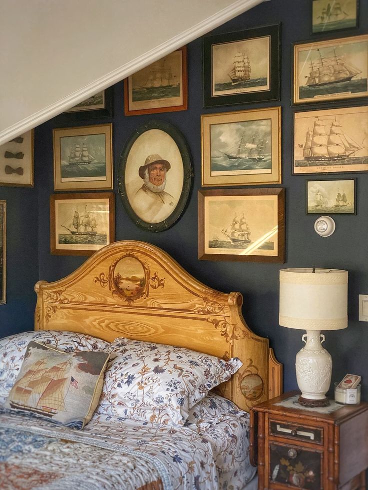 a bedroom with pictures on the wall above the bed and below the bed is a dresser