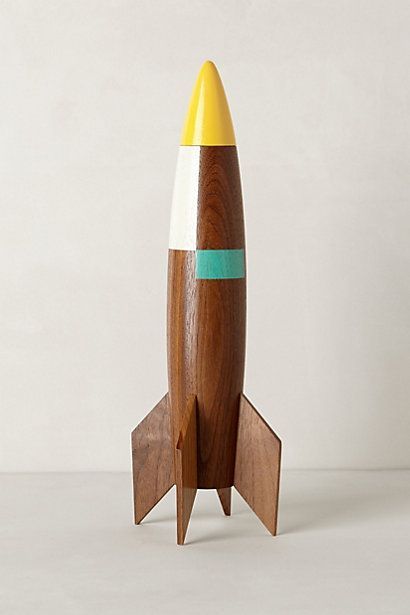 a wooden toy rocket sitting on top of a table