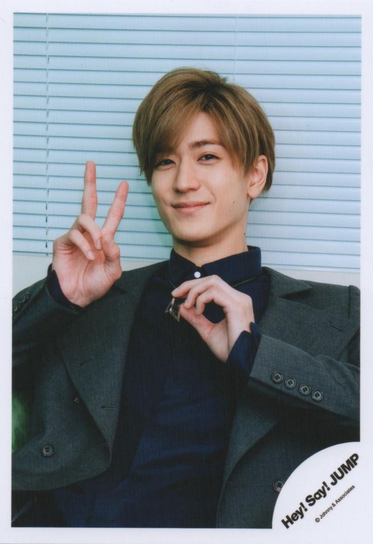 a young man making the peace sign with his fingers