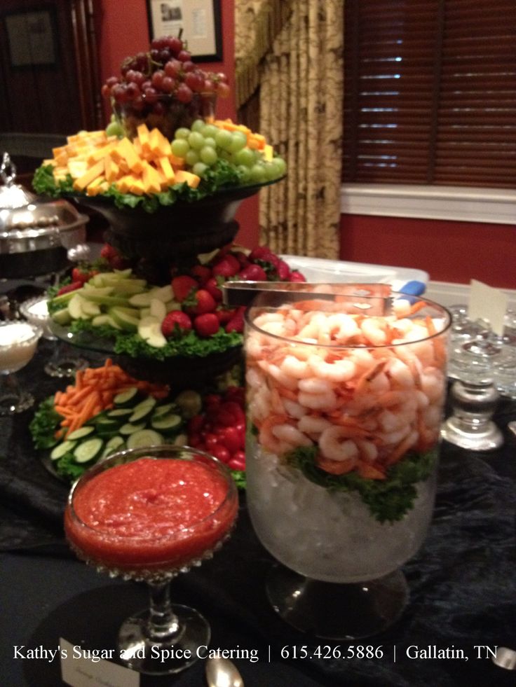 a table topped with lots of different types of food next to wine glasses and silverware