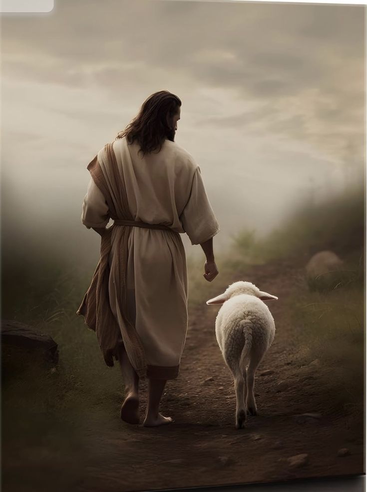 a man walking down a dirt road next to a sheep