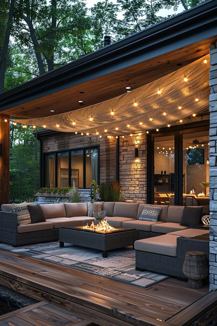 an outdoor living area is lit up with string lights