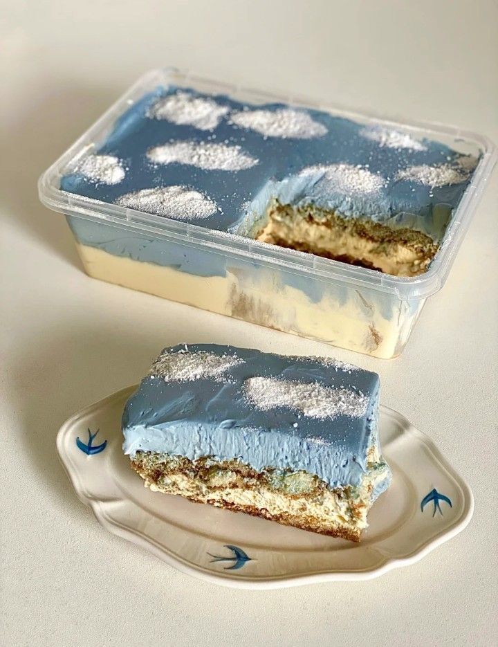 a piece of cake sitting on top of a plate next to it's container