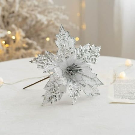 a snowflake decoration on a table next to a christmas tree