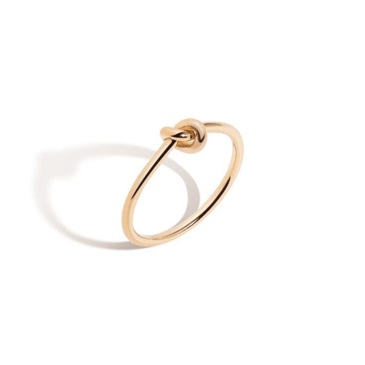 a gold ring with a knot on the middle and an open loop at the end