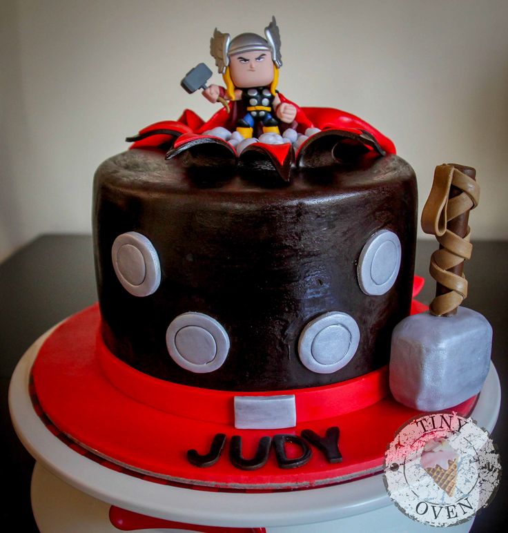 a birthday cake with an iron man figure on top