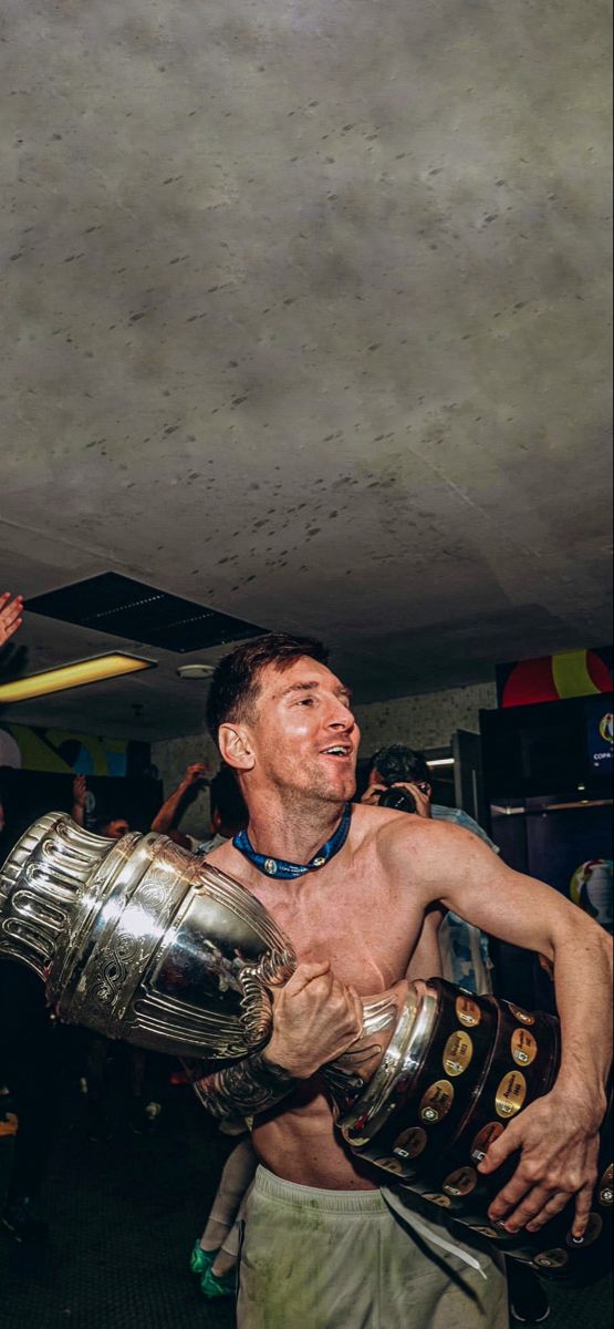 a man is holding a trophy in his hands