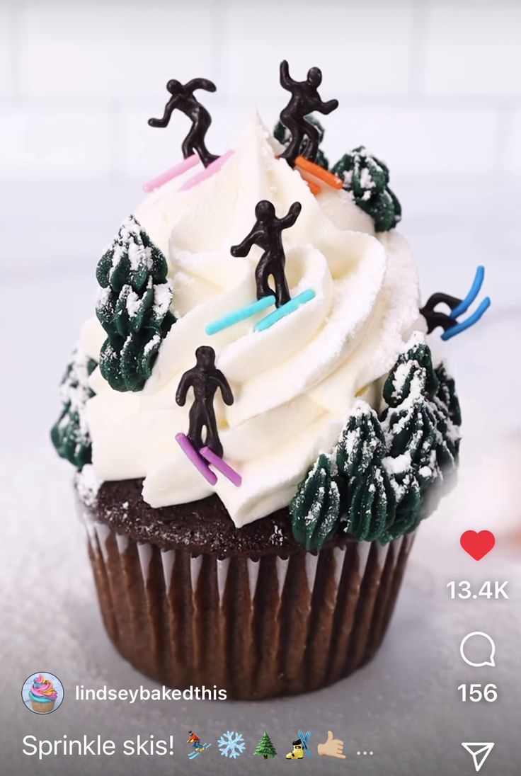 a cupcake with frosting and figurines on top