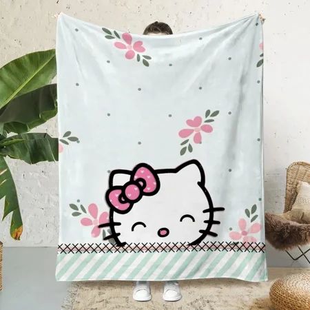 a hello kitty towel hanging on a wall next to a chair and potted plant