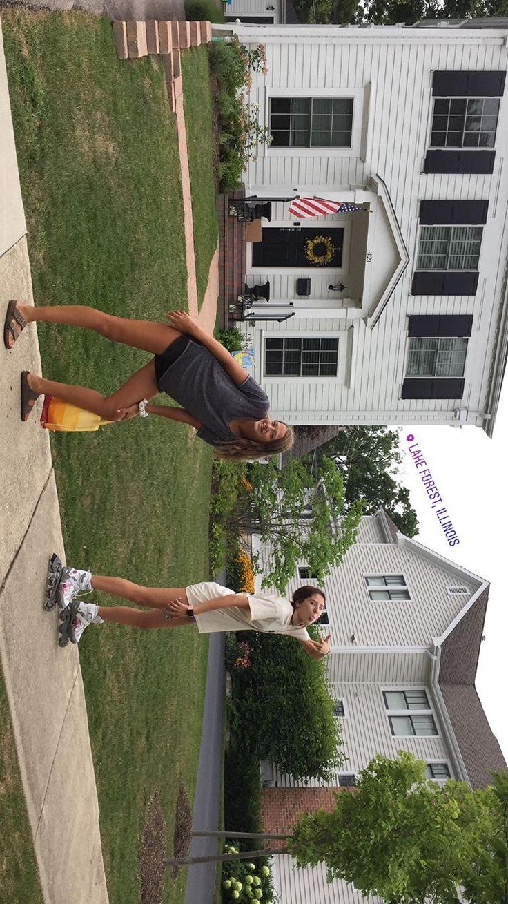 two people standing in front of a white house