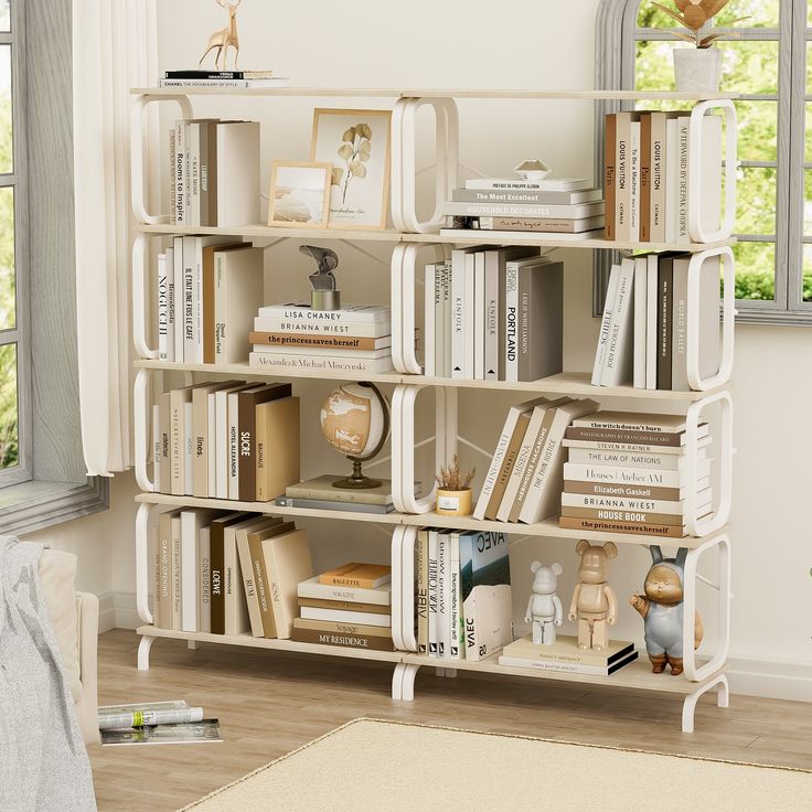 a bookshelf filled with lots of books next to a white chair and window