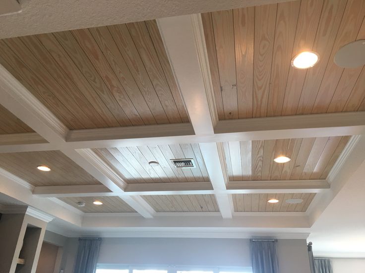 a living room filled with furniture and wooden ceilings