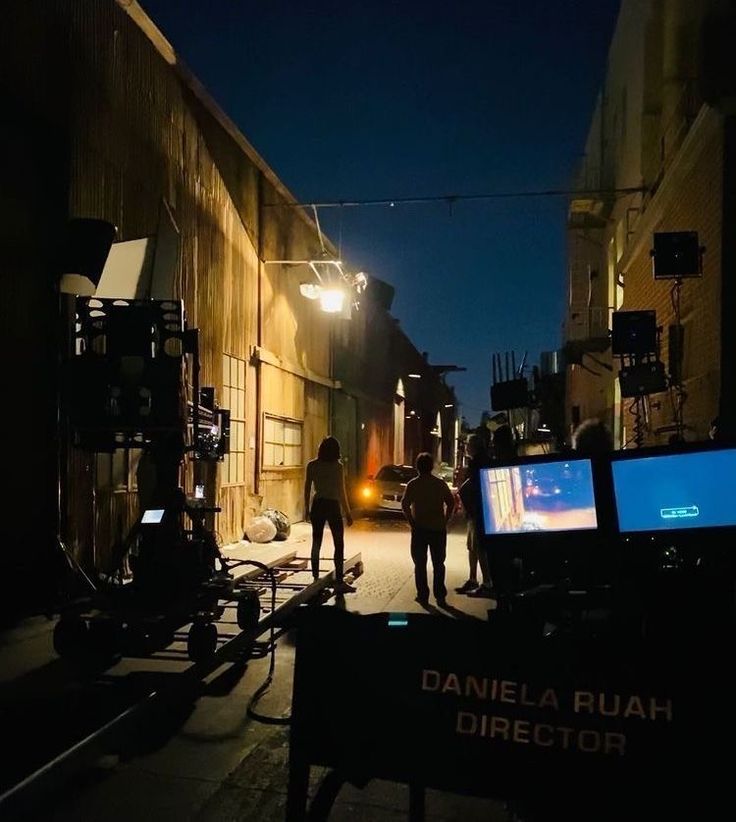 two men standing in an alley at night