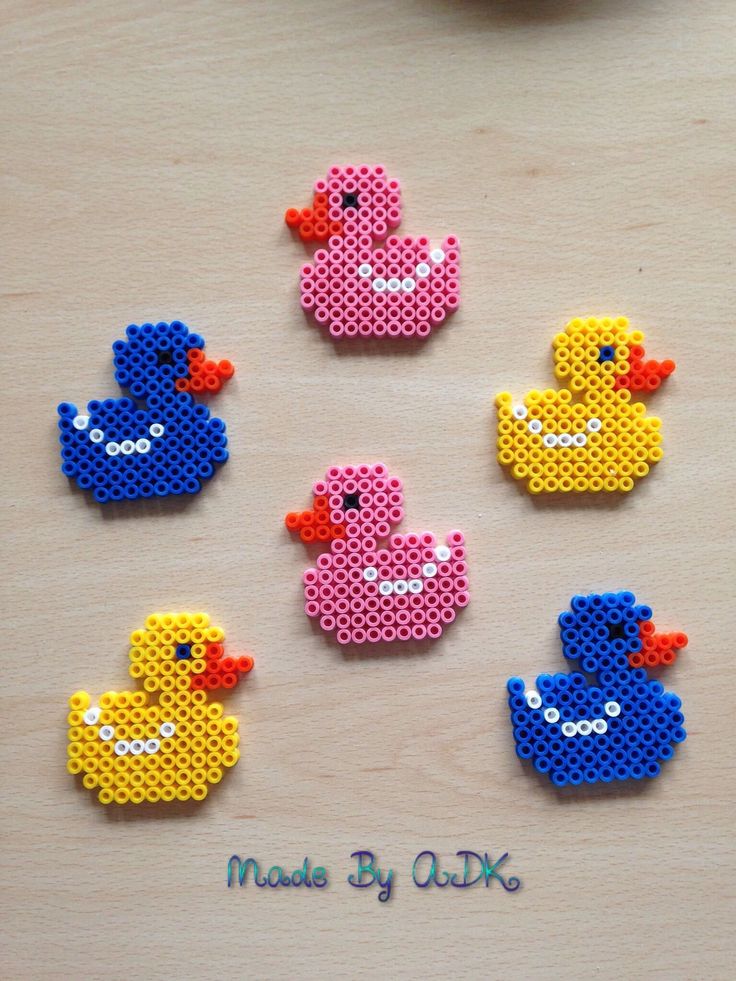 six perlery rubber ducks sitting on top of a wooden table