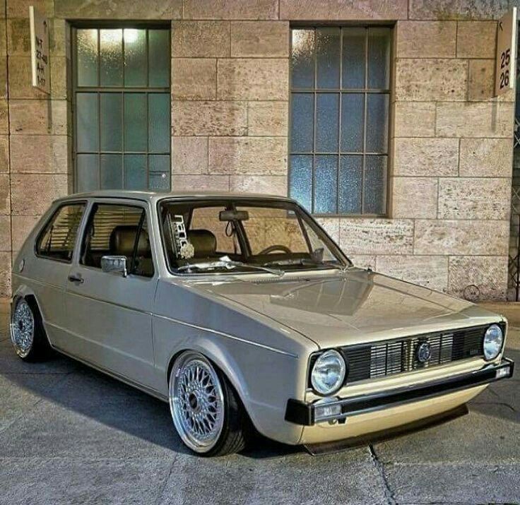 an old car parked in front of a building