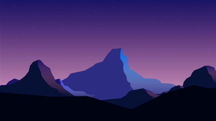 the mountains are silhouetted against a night sky