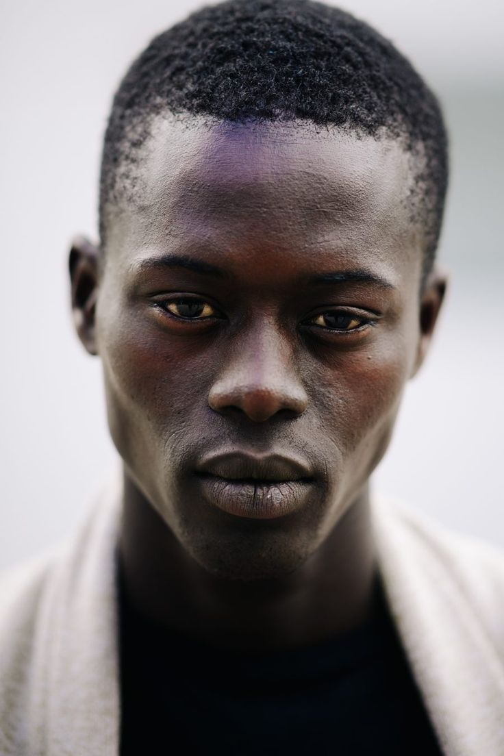 a close up of a person wearing a robe and looking at the camera with an intense look on his face