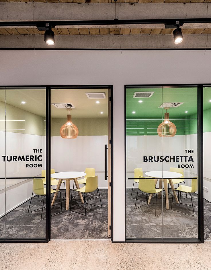 an office with glass walls and yellow chairs in front of the doors that read bruschetta