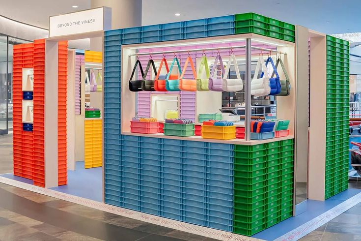 a colorful display case filled with bags and purses