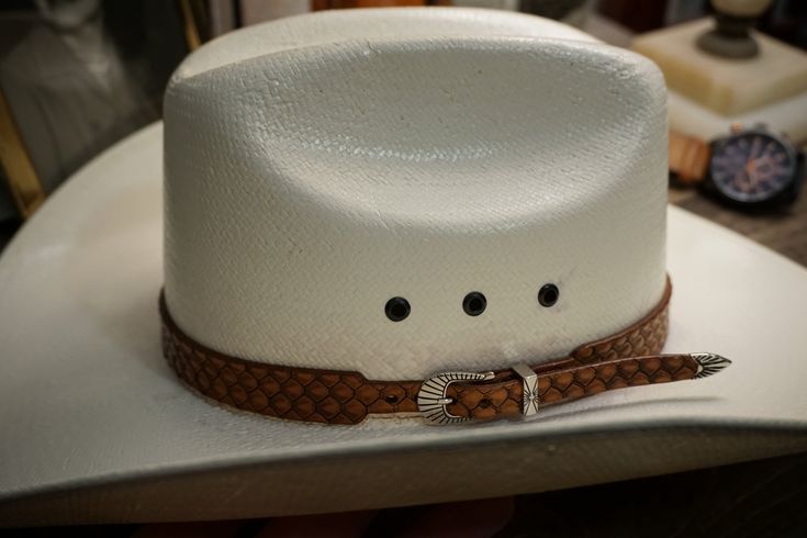 "Premium genuine leather hat band. Hand tooled in the style of a snake and presented in a luxurious English Bridle finish with an ornate metal buckle set and 3/4\" wide. Fits small to medium size hats ( sizes: 6 7/8 - 7 1/4). Size Large to Extra Large ( sizes: 7 3/8 - 7 3/4) also available. * Hand Tooled * 3/4\" Wide * Solid Leather * Premium Dyes * Ornate Metal Buckle Set * Moisture Resistant * Four Hole Adjustment * Made From Premium Hermann Oaks Hides * Made In USA" Tooled Leather Hat Band, Leather Hat Bands, Hat Bands, English Bridle, Leather Hat, Model Looks, Leather Hats, Western Hats, A Snake