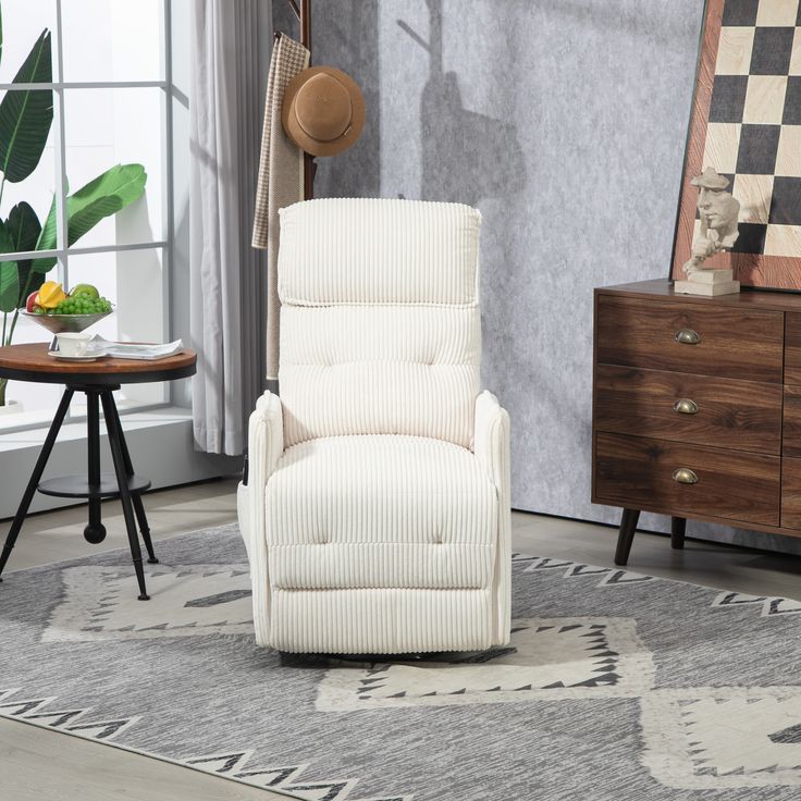 a white recliner sitting on top of a rug in a living room