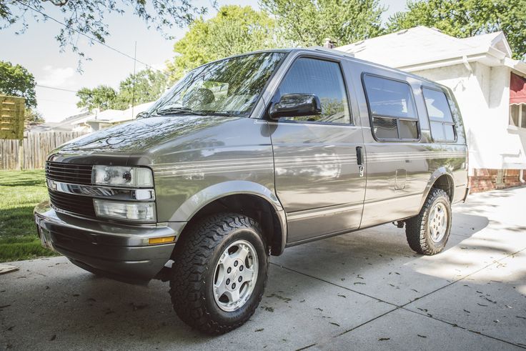 a silver van parked in front of a house