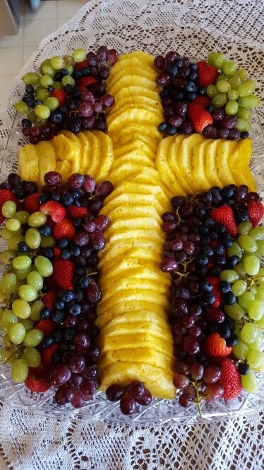 a cross made out of fruit on a table