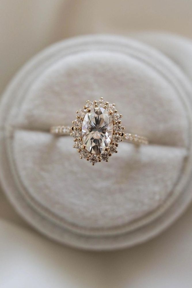 an engagement ring is sitting on top of a cushion