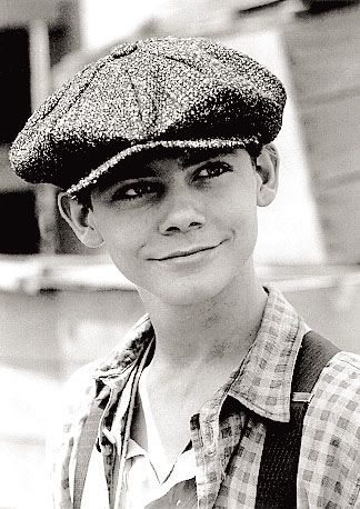 black and white photograph of a young man wearing a hat