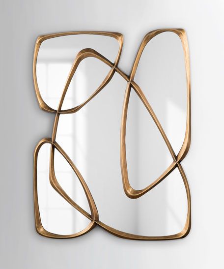 an art piece made out of gold metal with curved lines on the bottom and sides