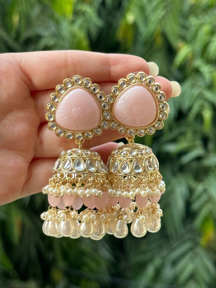 Beautiful engraved Jhumka earrings available in 2 stunning variations of pink. These earrings are high quality and are made to last. They are not too heavy and will be fine to wear all day long. They surely add a statement to any look! In case of any queries, please feel free to reach out. Happy shopping! Luxury White Jhumkas With Latkans, Luxury Fusion Style Chandelier Earrings With Latkans, Luxury Hallmarked Fusion Jhumkas, Luxury Tilla Jhumkas For Eid, Cheap Jhumkas For Diwali Celebration, Luxury Ornate Jhumkas For Festivals, Luxury Jhumkas With Stone Work For Festivals, Luxury Hand Set Jhumkas For Diwali, Luxury Multicolor Fusion Jhumkas