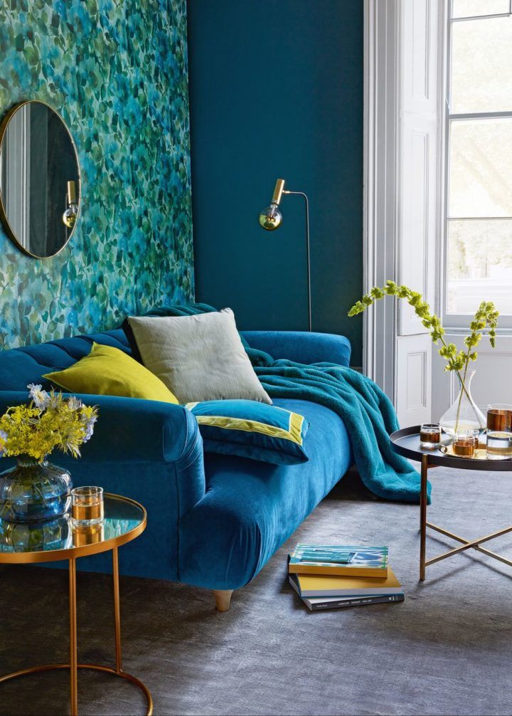 a living room with blue walls and furniture