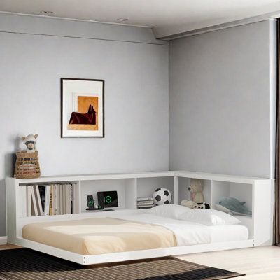 a bedroom with a bed, bookshelf and pictures on the wall above it