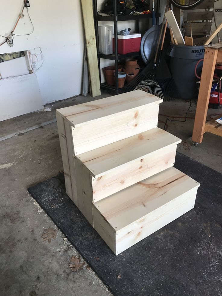 three wooden steps sitting in a garage