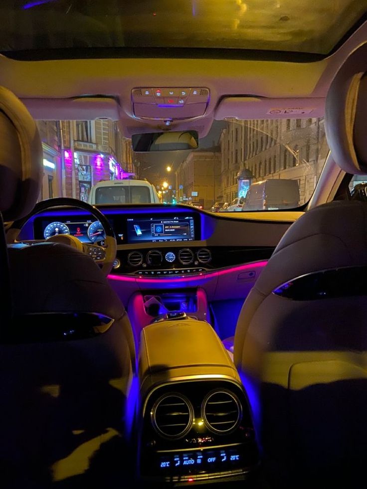 the interior of a car with its lights on and dashboard illuminated by blue leds