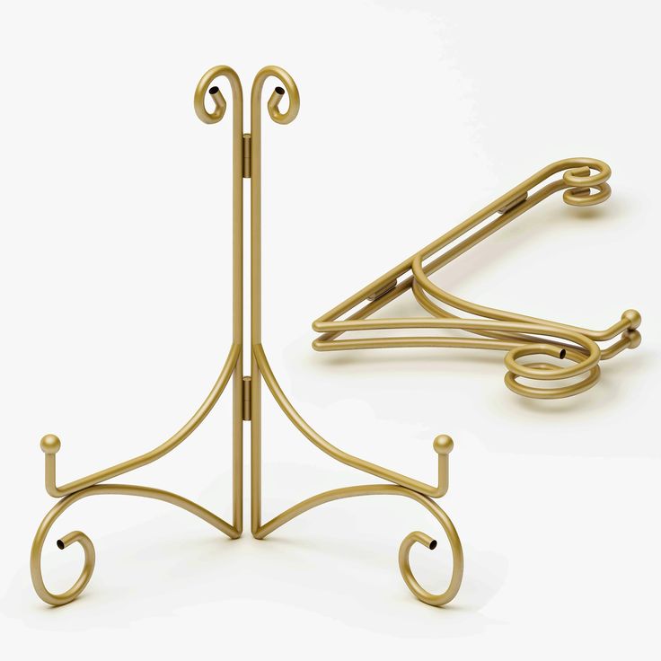 two gold - plated metal hooks are shown on a white surface, one is bent and the other has curved handles