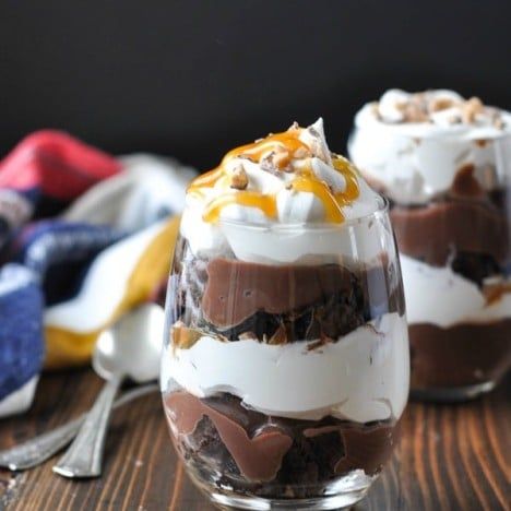 three desserts are sitting on a wooden table