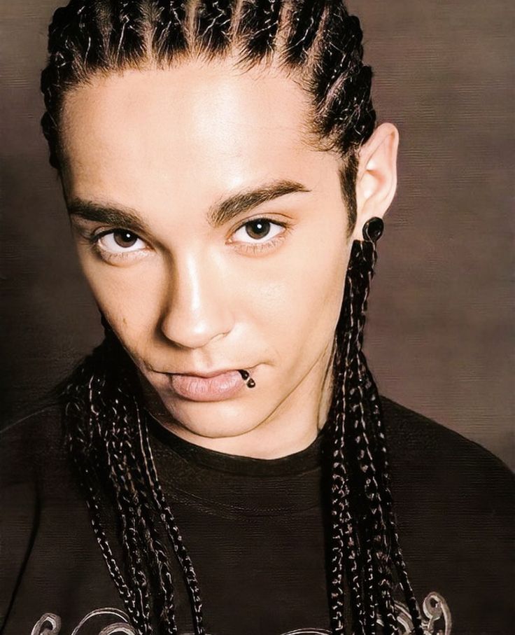 a woman with braids and piercing on her nose