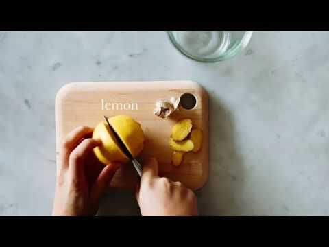 someone cutting up some fruit on top of a wooden cutting board with the word lemon