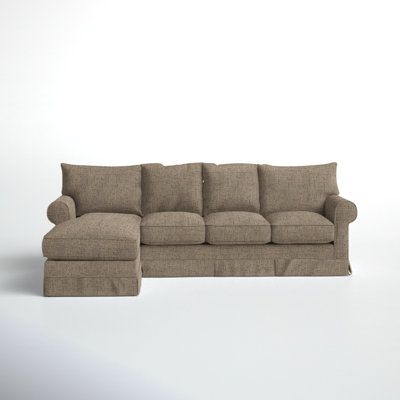 a couch and ottoman in front of a white background with the same fabric material on it