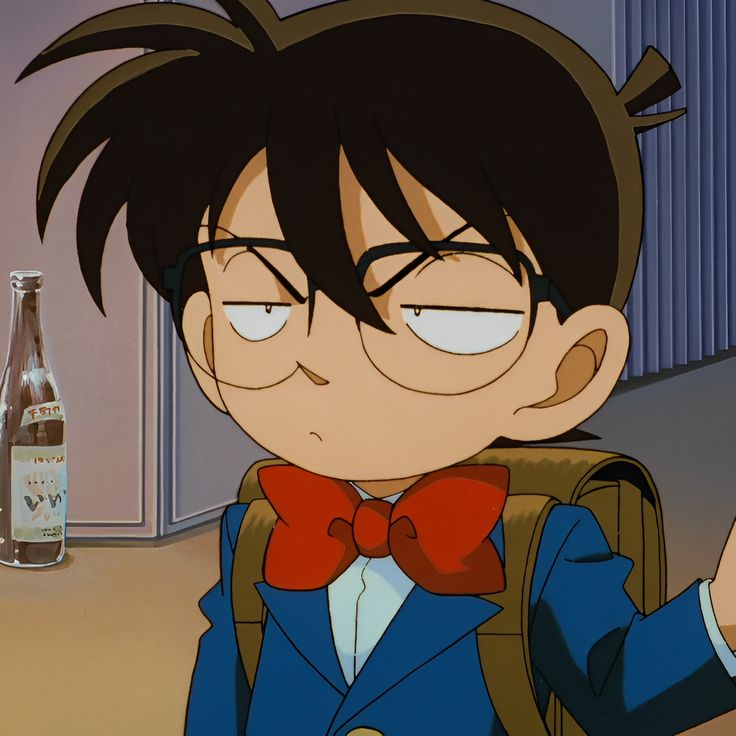 an anime character with glasses and a bow tie pointing to the side while wearing a backpack