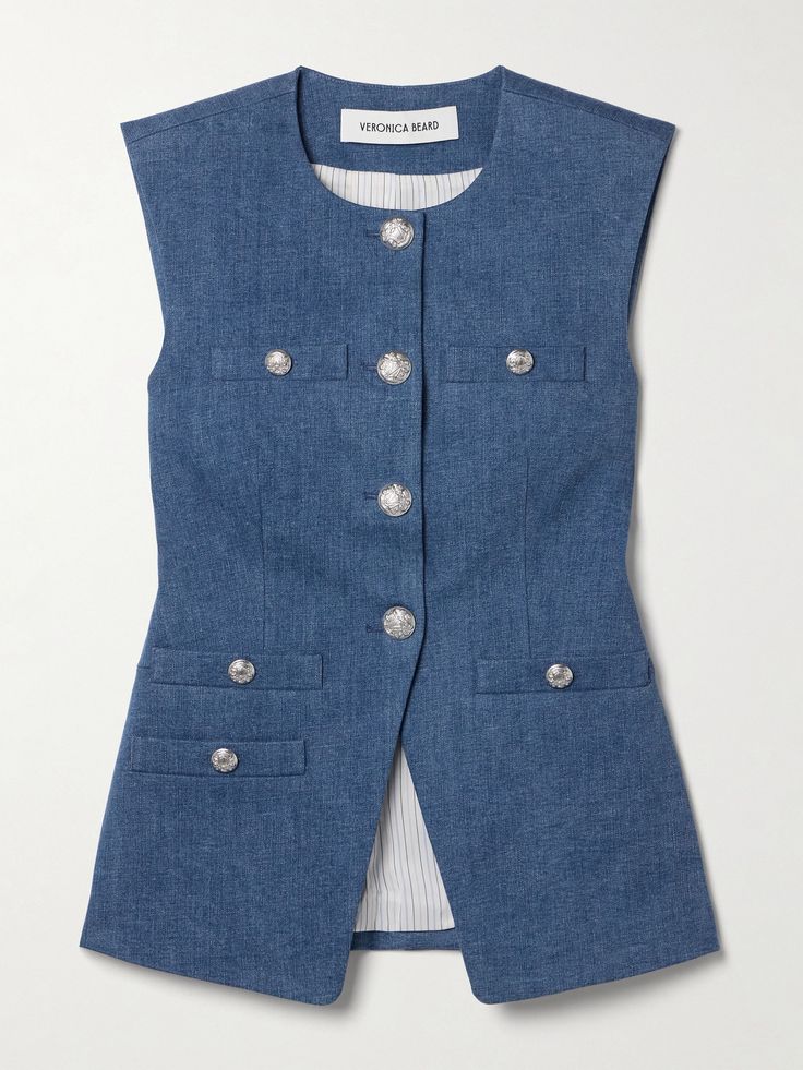 Veronica Beard's 'Tamara' vest is adorned with polished silver-tone buttons depicting the brand's regal crest. It's tailored from smooth denim and has a notched front, so it sits nicely over your hips. The full lining ensures a smooth fit. Luxury Miu Miu Tops For Workwear, Tailored Shirts For Women, Classic Denim Workwear Vest With Pockets, Classic Denim Vest For Work, Classic Denim Vest With Button Closure For Work, Denim Vest With Buttons For Workwear, Classic Denim Vest With Button Closure, Fitted Denim Vest With Snap Buttons For Work, Blue Denim Vest For Work With Buttons