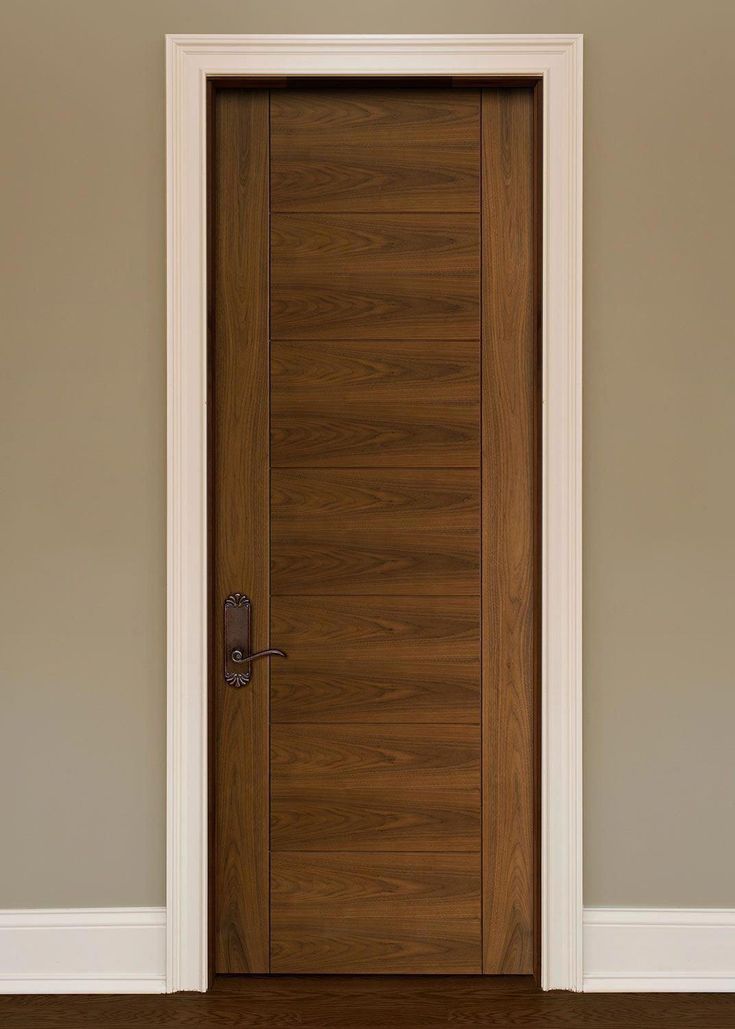 a wooden door in an empty room