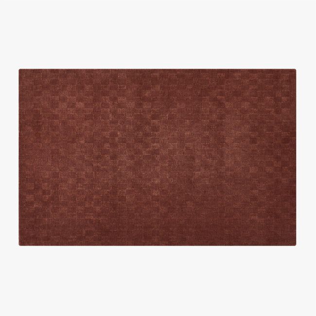 an area rug with brown squares on the top and bottom, in front of a white background